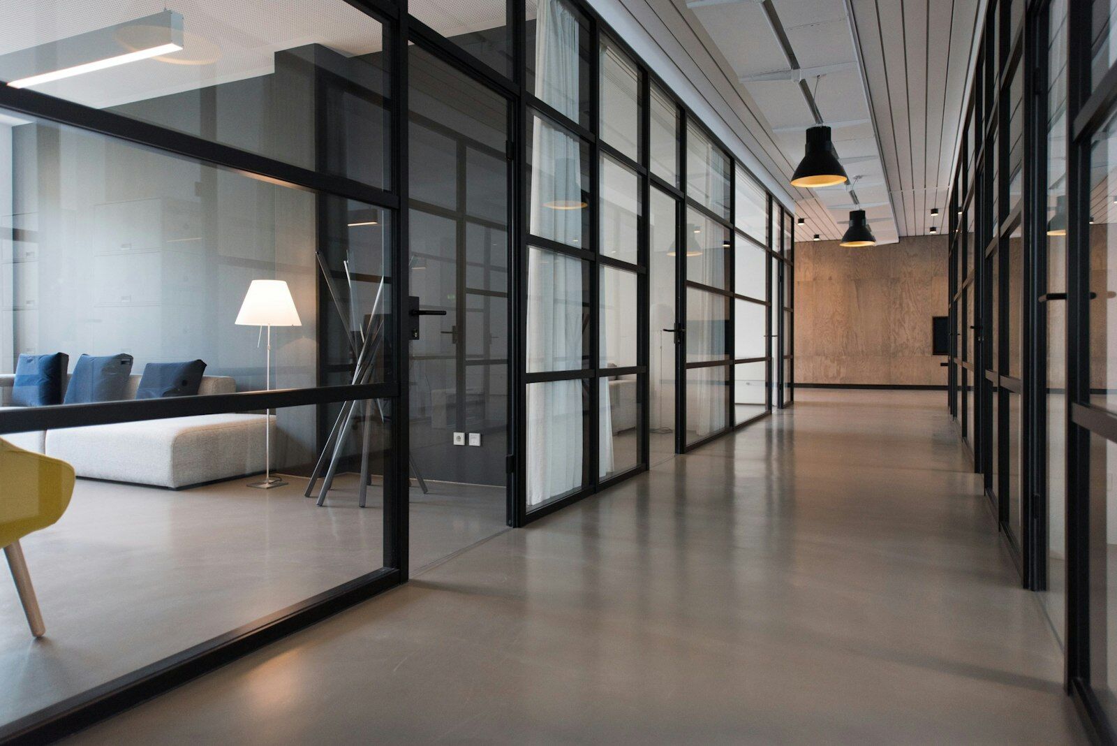 Modern glass-walled office corridor, representing the enterprise and governance settings Avisha Global works in