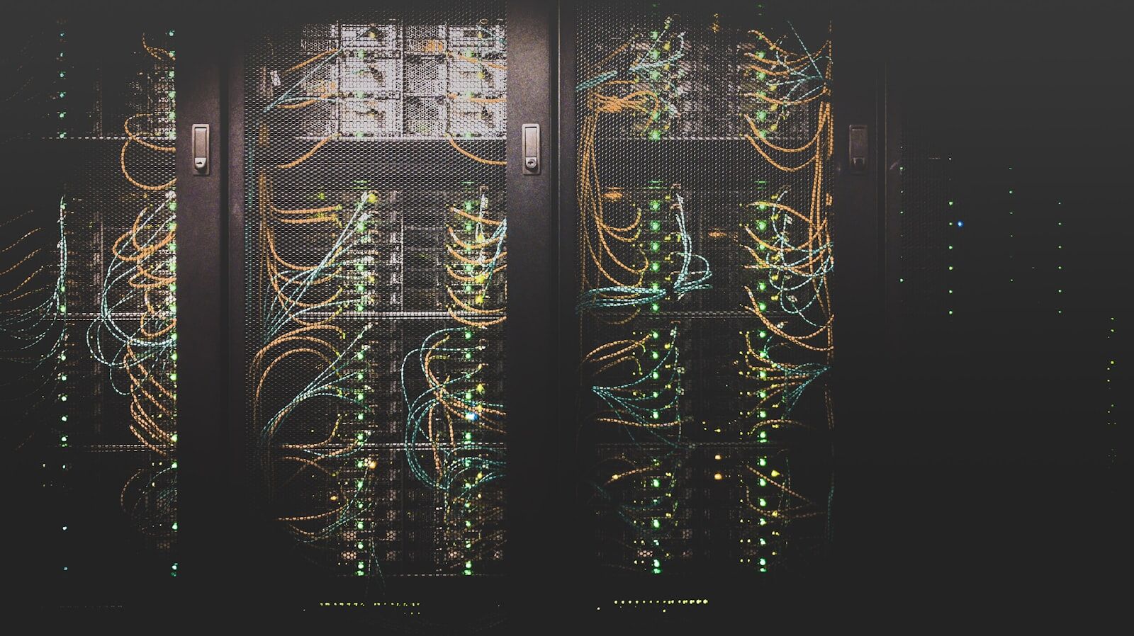 A cold aisle of server cabinets in a modern data centre